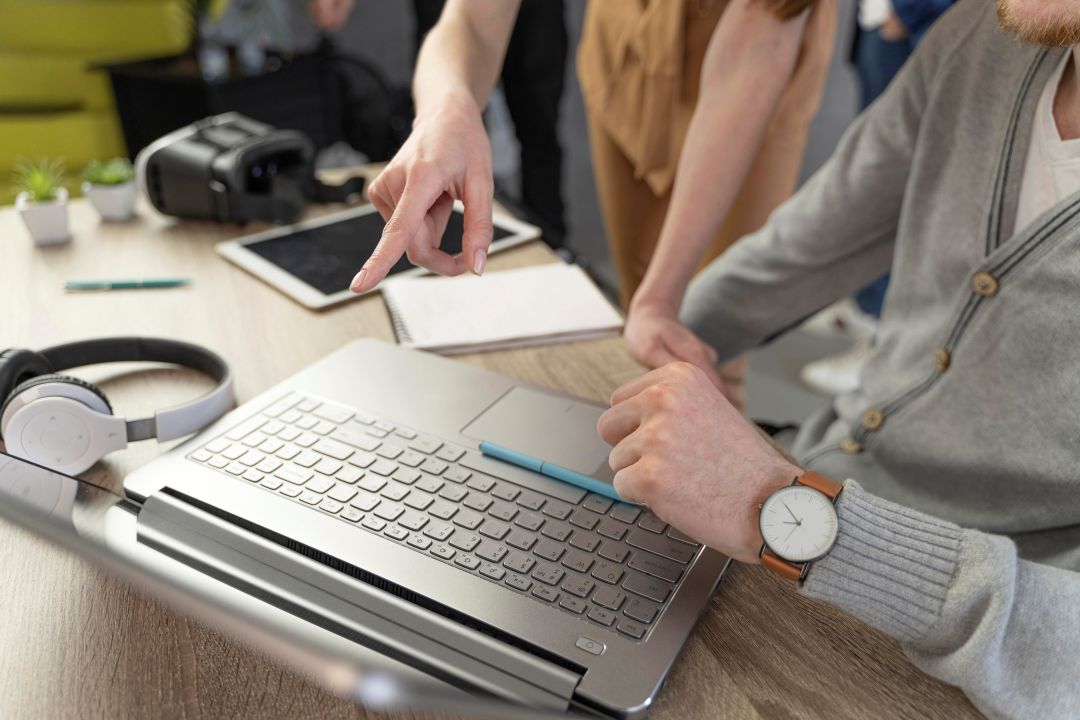 high-angle-man-woman-working-with-laptop-headphones